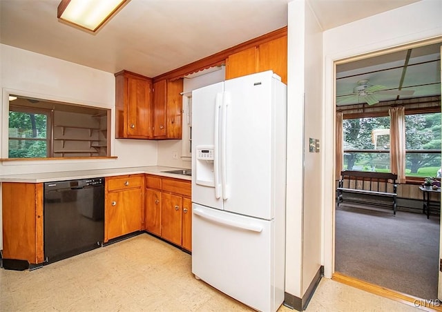 3959 Number Nine Rd, Cazenovia, NY 13035 - kitchen with white refrigerator with ice dispenser, black dishwasher, brown cabinets, and healthy amount of natural light