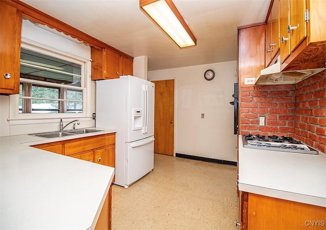 3959 Number Nine Rd, Cazenovia, NY 13035 - kitchen with white appliances, light flooring, brown cabinets, light countertops, and under cabinet range hood