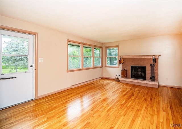 3959 Number Nine Rd, Cazenovia, NY 13035 - unfurnished living room featuring light wood-style flooring, a baseboard radiator, and a fireplace