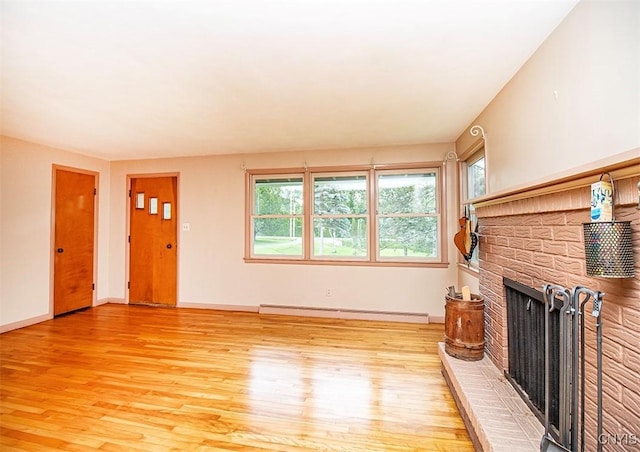 3959 Number Nine Rd, Cazenovia, NY 13035 - unfurnished living room with a baseboard heating unit, a fireplace, healthy amount of natural light, and light wood-type flooring