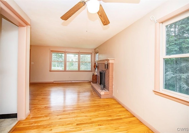 3959 Number Nine Rd, Cazenovia, NY 13035 - unfurnished living room with light wood finished floors, a fireplace, a baseboard heating unit, ceiling fan, and vaulted ceiling