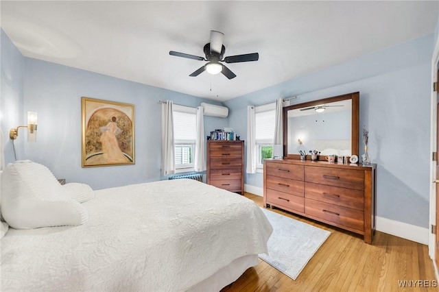 176 Mount Vernon Rd, Amherst, NY 14226 - bedroom featuring a wall unit AC, light wood finished floors, and ceiling fan