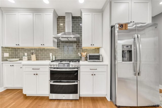 176 Mount Vernon Rd, Amherst, NY 14226 - kitchen featuring stainless steel appliances, wall chimney exhaust hood, light countertops, light wood-style flooring, and recessed lighting