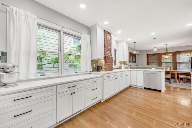 176 Mount Vernon Rd, Amherst, NY 14226 - kitchen with stainless steel dishwasher, light wood-style flooring, white cabinets, light countertops, and a peninsula