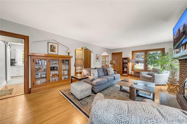 176 Mount Vernon Rd, Amherst, NY 14226 - living room featuring wood finished floors and a brick fireplace