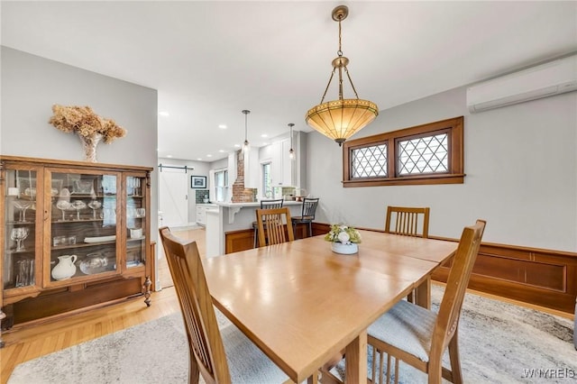 176 Mount Vernon Rd, Amherst, NY 14226 - dining space featuring a barn door, a wall mounted air conditioner, light wood finished floors, and recessed lighting