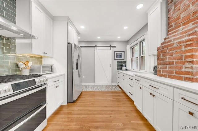 176 Mount Vernon Rd, Amherst, NY 14226 - kitchen with stainless steel appliances, a barn door, range hood, white cabinetry, and recessed lighting