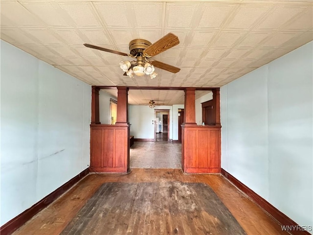 64 Timon St, Buffalo, NY 14211 - empty room featuring decorative columns, ceiling fan, and wood-type flooring
