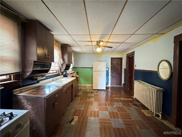 64 Timon St, Buffalo, NY 14211 - kitchen featuring freestanding refrigerator, a drop ceiling, wainscoting, range, and a ceiling fan