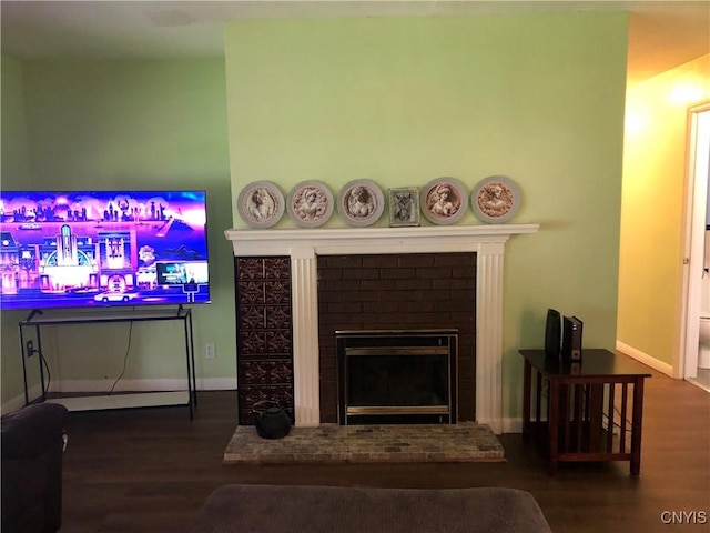 1407 N James St, Rome-Inside, NY 13440 - living area featuring wood finished floors and a brick fireplace