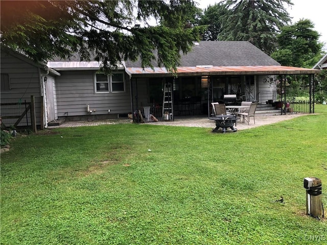 1407 N James St, Rome-Inside, NY 13440 - rear view of property featuring a patio area, a lawn, and an outdoor fire pit