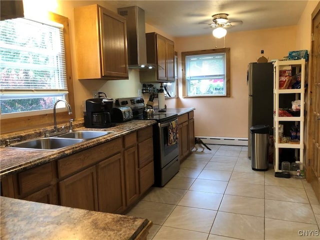 1407 N James St, Rome-Inside, NY 13440 - kitchen with stainless steel range with electric cooktop, baseboard heating, wall chimney exhaust hood, and healthy amount of natural light