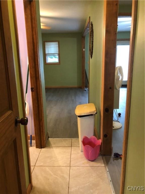 1407 N James St, Rome-Inside, NY 13440 - corridor featuring healthy amount of natural light and light tile patterned floors