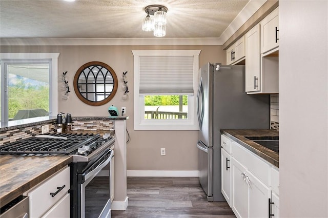 716 Flynn Rd, Greece, NY 14612 - kitchen featuring appliances with stainless steel finishes, white cabinetry, dark wood-style flooring, decorative backsplash, and butcher block countertops
