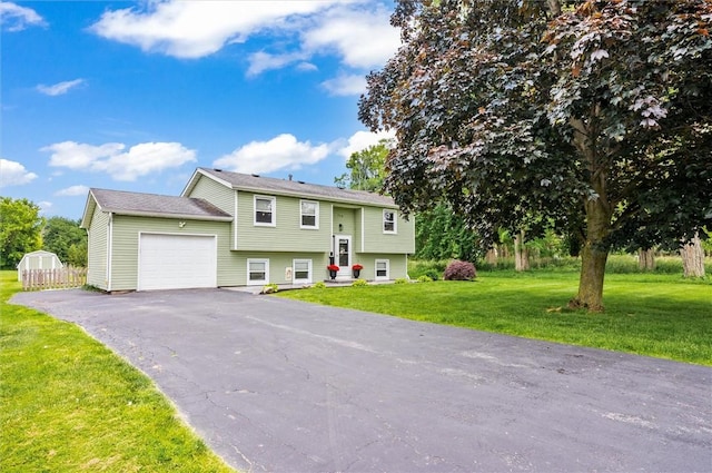 716 Flynn Rd, Greece, NY 14612 - raised ranch with a garage, asphalt driveway, and a front yard