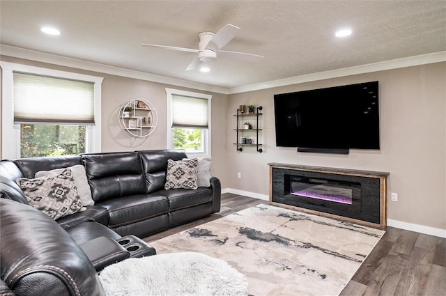 716 Flynn Rd, Greece, NY 14612 - living area featuring crown molding, a ceiling fan, wood finished floors, recessed lighting, and a glass covered fireplace