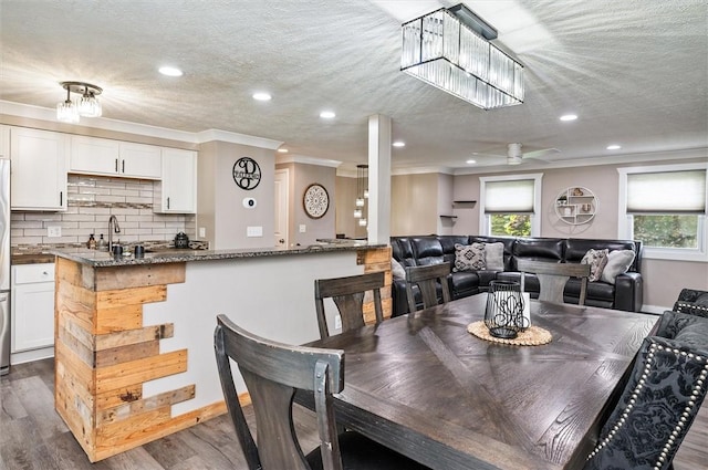 716 Flynn Rd, Greece, NY 14612 - dining room with healthy amount of natural light, crown molding, dark wood-type flooring, recessed lighting, and a ceiling fan
