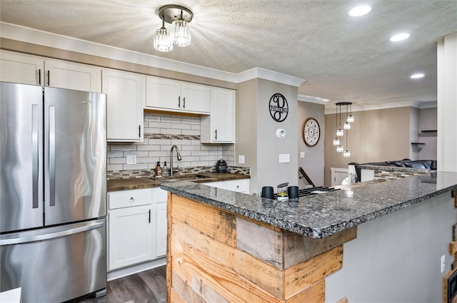 716 Flynn Rd, Greece, NY 14612 - kitchen featuring freestanding refrigerator, ornamental molding, white cabinets, dark wood-style floors, and tasteful backsplash
