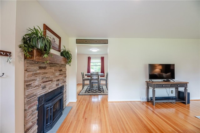 284 Woodruff Dr, Webster, NY 14580 - living area featuring light wood finished floors and a stone fireplace