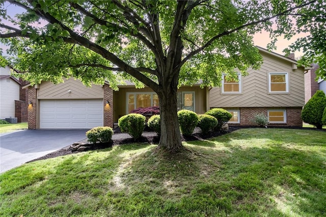 55 Creighton Ln, Greece, NY 14612 - split level home with driveway, brick siding, a front yard, and an attached garage