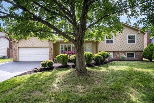 55 Creighton Ln, Greece, NY 14612 - tri-level home featuring asphalt driveway, brick siding, a front yard, and an attached garage