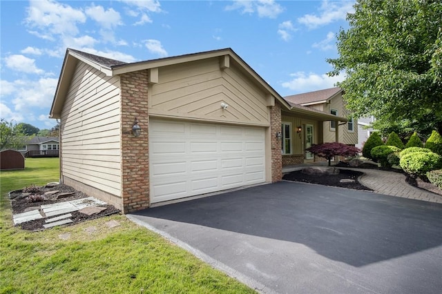 55 Creighton Ln, Greece, NY 14612 - view of front of house featuring asphalt driveway, a garage, and a front lawn