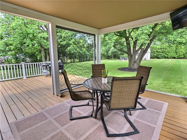 40 Ice Rose Ln, Henrietta, NY 14623 - wooden deck featuring outdoor dining space, a yard, view of wooded area, and area for grilling