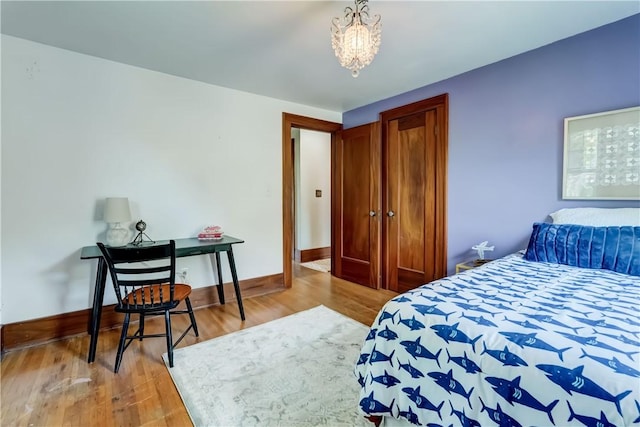 79 Rawlinson Rd, Irondequoit, NY 14617 - bedroom featuring wood finished floors, a chandelier, and a closet