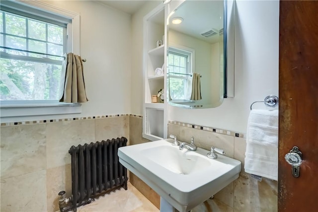 79 Rawlinson Rd, Irondequoit, NY 14617 - bathroom featuring radiator heating unit and tile walls