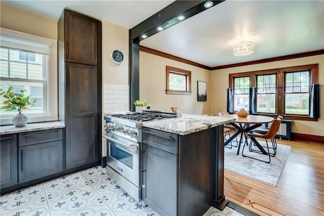 79 Rawlinson Rd, Irondequoit, NY 14617 - kitchen with high end stainless steel range, a peninsula, crown molding, light stone countertops, and light wood-type flooring