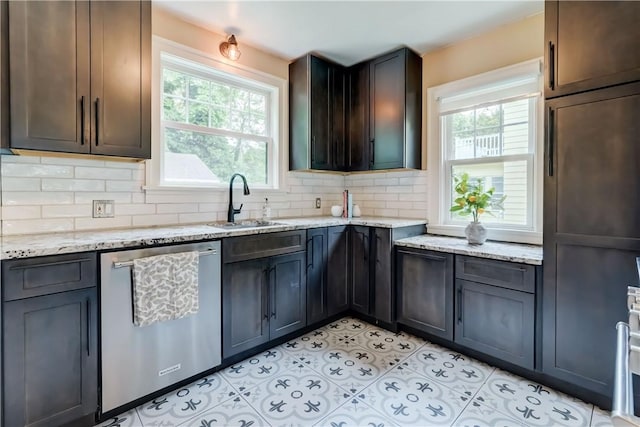 79 Rawlinson Rd, Irondequoit, NY 14617 - kitchen featuring stainless steel dishwasher, backsplash, light stone countertops, and light tile patterned floors