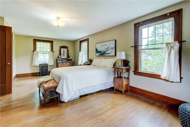 79 Rawlinson Rd, Irondequoit, NY 14617 - bedroom featuring multiple windows, radiator, and light wood-style flooring