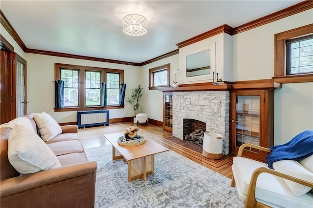 79 Rawlinson Rd, Irondequoit, NY 14617 - living room featuring radiator, light wood-style floors, ornamental molding, and a brick fireplace