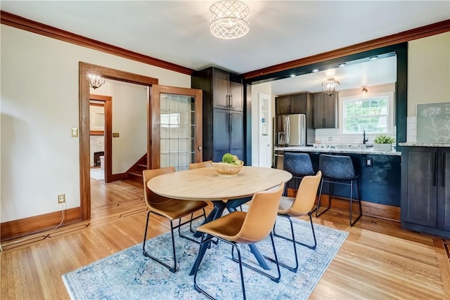 79 Rawlinson Rd, Irondequoit, NY 14617 - dining room with light wood-style flooring and ornamental molding