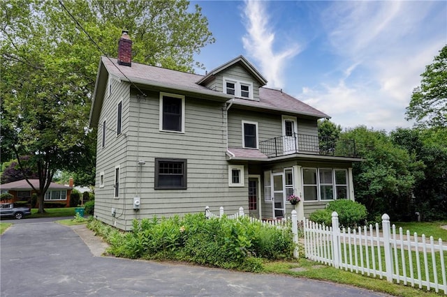 79 Rawlinson Rd, Irondequoit, NY 14617 - view of front facade with a balcony and a chimney