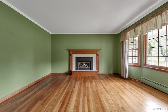 218 Hall Rd, Lancaster, NY 14059 - unfurnished living room with a baseboard heating unit, crown molding, light wood-style flooring, and a glass covered fireplace