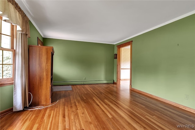 218 Hall Rd, Lancaster, NY 14059 - empty room featuring wood finished floors, a baseboard radiator, and crown molding