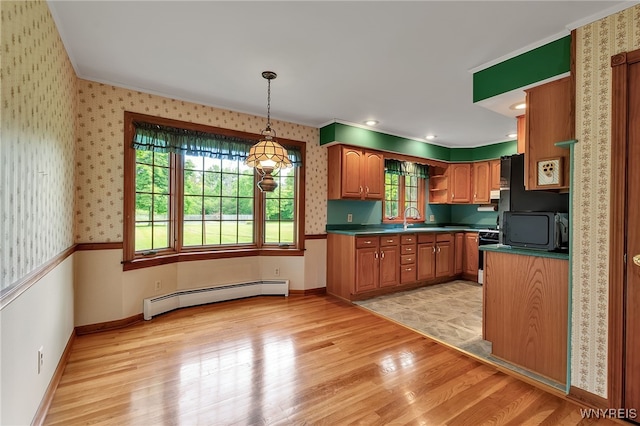218 Hall Rd, Lancaster, NY 14059 - kitchen with baseboard heating, dark countertops, light wood-style flooring, ornamental molding, and brown cabinetry