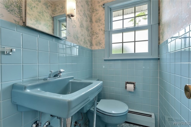 218 Hall Rd, Lancaster, NY 14059 - bathroom featuring a baseboard heating unit, tile walls, wallpapered walls, and a wainscoted wall