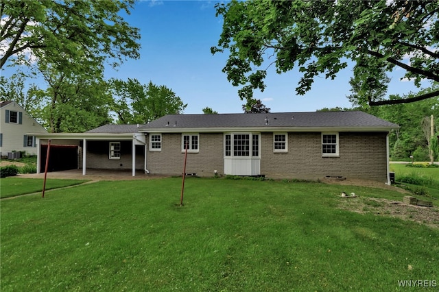 218 Hall Rd, Lancaster, NY 14059 - back of property featuring brick siding, a yard, concrete driveway, an attached garage, and crawl space