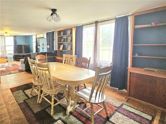 52 Maple Ave, Cohocton, NY 14826 - dining space with wood finished floors and a wall mounted air conditioner
