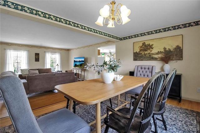 11131 Harlow Rd, Darien, NY 14004 - dining area with a chandelier, wood finished floors, and crown molding