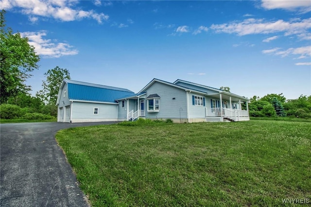 11131 Harlow Rd, Darien, NY 14004 - view of front of house featuring covered porch, a metal roof, a front yard, and driveway