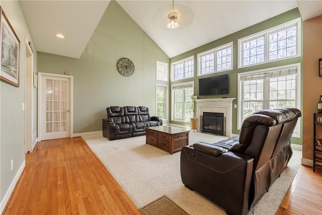 16 Hepburn Ln, Pittsford, NY 14534 - living area with high vaulted ceiling, light wood finished floors, and a tile fireplace