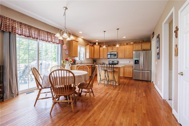 16 Hepburn Ln, Pittsford, NY 14534 - dining space with light wood finished floors, healthy amount of natural light, a chandelier, and recessed lighting