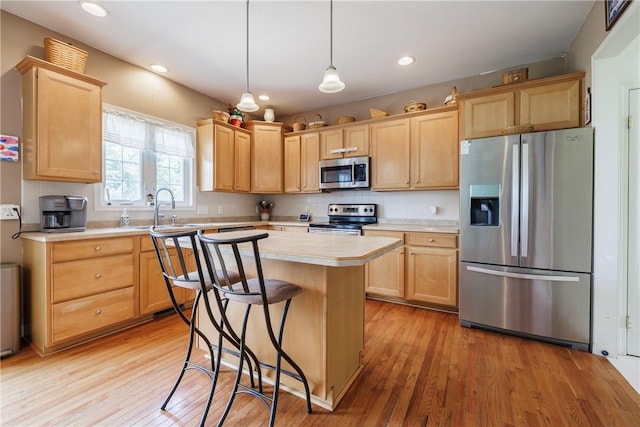 16 Hepburn Ln, Pittsford, NY 14534 - kitchen with stainless steel appliances, light brown cabinetry, light countertops, light wood-style floors, and recessed lighting