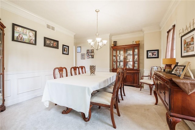 16 Hepburn Ln, Pittsford, NY 14534 - dining area with a chandelier, ornamental molding, light carpet, a wainscoted wall, and a decorative wall