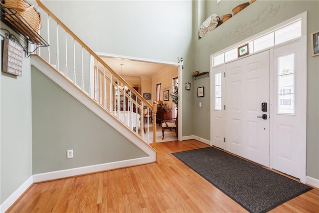 16 Hepburn Ln, Pittsford, NY 14534 - entrance foyer with stairway, a towering ceiling, and wood finished floors