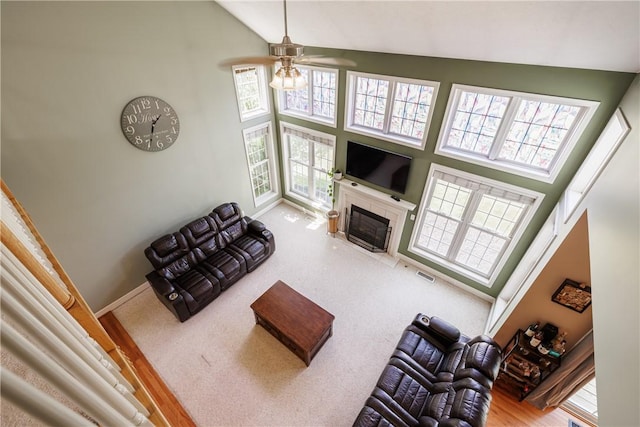 16 Hepburn Ln, Pittsford, NY 14534 - carpeted living area featuring ceiling fan, high vaulted ceiling, and a fireplace with flush hearth