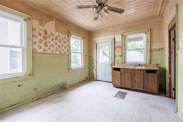 48 Rosedale St, Rochester, NY 14620 - kitchen featuring healthy amount of natural light, wainscoting, wallpapered walls, light countertops, and ceiling fan
